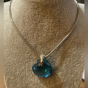 Swarovski: Retired blue topaz clam shell “ wonders of the sea” on a silver chain